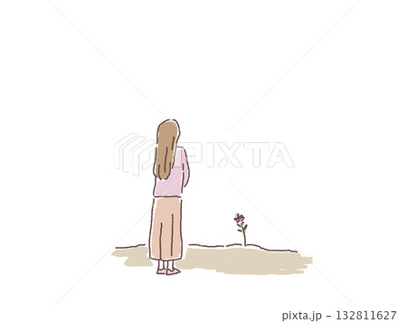 一輪の花を見つめる女性の後ろ姿 132811627