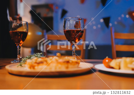 Joyful office Halloween party with coworkers in costumes, celebrating with drinks and laughter, fostering teamwork and festive spirit 132811632