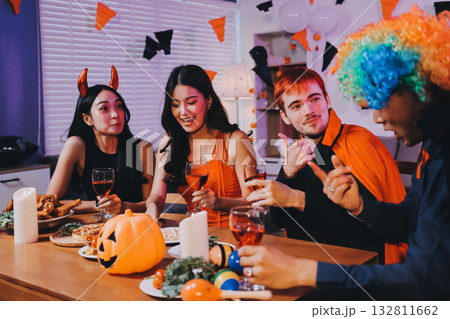 Joyful office Halloween party with coworkers in costumes, celebrating with drinks and laughter, fostering teamwork and festive spirit 132811662