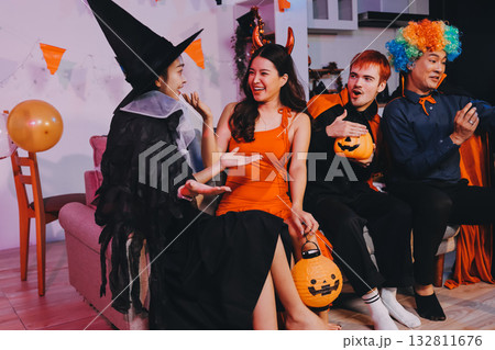 Joyful office Halloween party with coworkers in costumes, celebrating with drinks and laughter, fostering teamwork and festive spirit Joyful office Halloween party with coworkers in costumes, celebrating with drinks and laughter, fostering teamwork and festive spirit 132811676