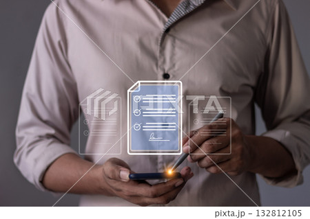 Young man with smartphone mobile hand using a pen touching to sign a Online Business Contract, 132812105