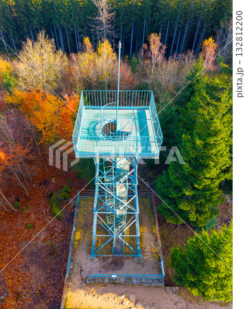 Explore the historic Slovanka Lookout Tower nestled in the Jizera Mountains. This iron tower, the oldest of its kind in the Czech Republic, offers stunning views surrounded by vibrant fall foliage. 132812200