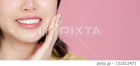 Skincare. Young woman smiling and touching her face, showcasing healthy skin. Skincare. Young woman smiling and touching her face, showcasing healthy skin. 132812471