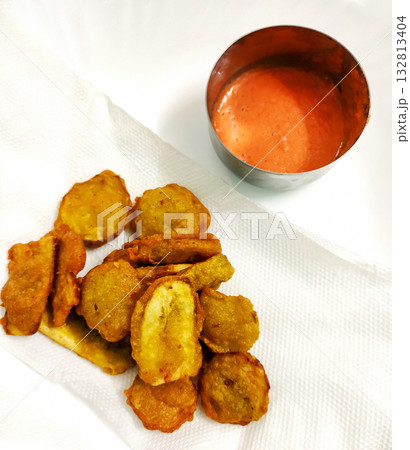 Banana Fritters Served with Spicy Red Chutney Banana Fritters Served with Spicy Red Chutney 132813404
