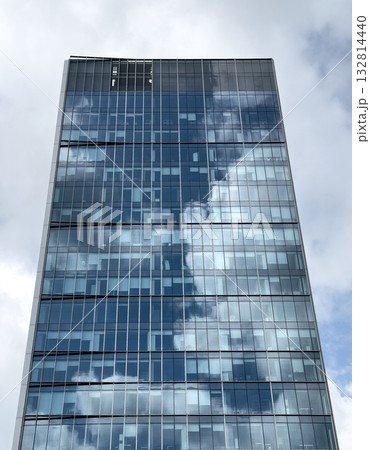 Futuristic skyscraper rising. Modern corporate tower with glass windows and reflective facade, Futuristic skyscraper rising. Modern corporate tower with glass windows and reflective facade, 132814440