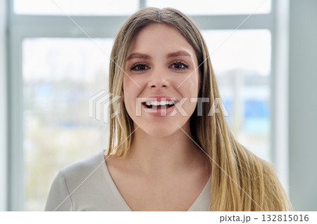 Headshot portrait of young happy woman looking at camera Headshot portrait of young happy woman looking at camera 132815016
