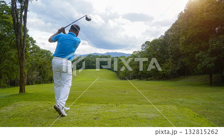 Golfer playing golf in the evening golf course, on sun set evening time. Golfer playing golf in the evening golf course, on sun set evening time. 132815262