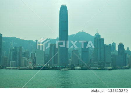 The view from Tsim Sha Tsui Victoria Harbour, Hong Kong. Iconic terminal and Hong Kong cityscape. Travel and nature scene.  132815279