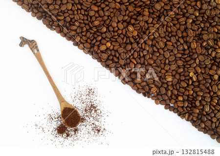Coffee beans in a wooden scoop isolated on a white background. Roasted coffee beans isolated. 132815488