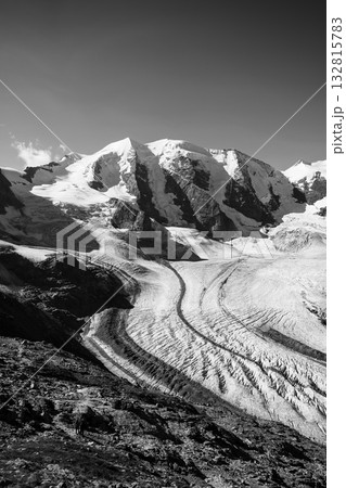 Majestic peaks of Piz Palu tower over the Pers Glacier in the Bernina Range. The landscape showcases the stark beauty of ice and rock in Graubunden, Switzerland. 132815783