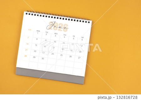 Top view of June 2026 desk calendar on yellow color background. Top view of June 2026 desk calendar on yellow color background. 132816728