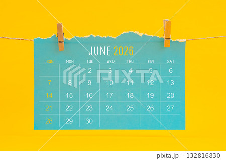June 2026 calendar tearing hanged with brown rope on yellow color background. 132816830