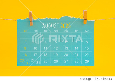 August 2026 calendar tearing hanged with brown rope on yellow color background. August 2026 calendar tearing hanged with brown rope on yellow color background. 132816833