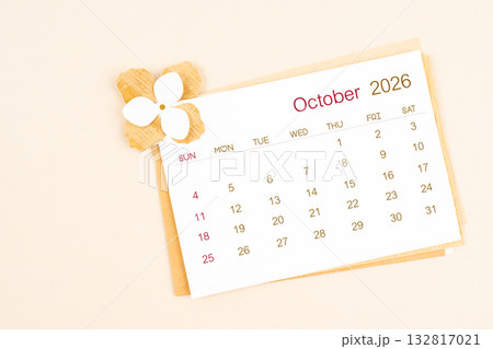 October 2026 calendar with origami flower paper on beige color background. October 2026 calendar with origami flower paper on beige color background. 132817021