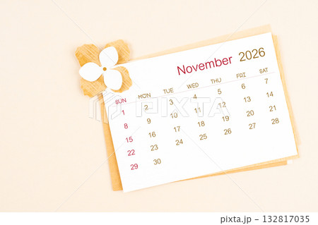 November 2026 calendar with origami flower paper on beige color background. 132817035