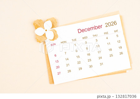 December 2026 calendar with origami flower paper on beige color background. December 2026 calendar with origami flower paper on beige color background. 132817036