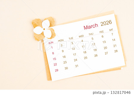 March 2026 calendar with origami flower paper on beige color background. March 2026 calendar with origami flower paper on beige color background. 132817046