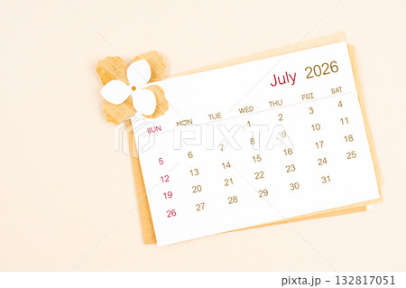 July 2026 calendar with origami flower paper on beige color background. July 2026 calendar with origami flower paper on beige color background. 132817051