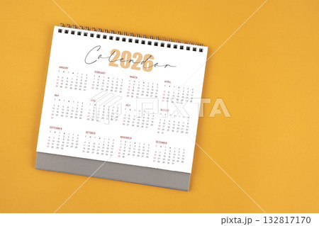 2026 yearly desk calendar on yellow color background, Flat lay. 132817170