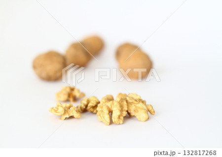 Peeled walnut closeup. Golden walnut kernel on a white background. Healthy foods. Selective Focus. 132817268