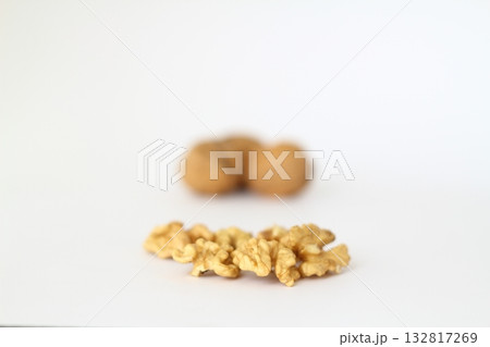 Peeled walnut closeup. Golden walnut kernel on a white background. Healthy foods. Selective Focus. Peeled walnut closeup. Golden walnut kernel on a white background. Healthy foods. Selective Focus. 132817269