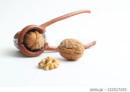 Walnuts with nutcracker isolated on white background Walnuts with nutcracker isolated on white background 132817283