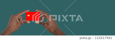 Hand holding bank card close up. African American male showing modern credit card concept for 132817481