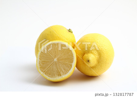 Ripe whole yellow lemon citrus fruit with lemon slice isolated on white background with clipping path. Ripe whole yellow lemon citrus fruit with lemon slice isolated on white background with clipping path. 132817787