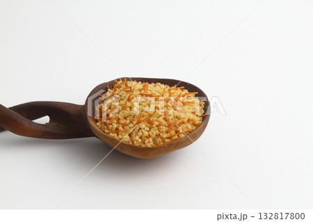 dry bulgur wheat in wooden spoon isolated on white background. top view 132817800