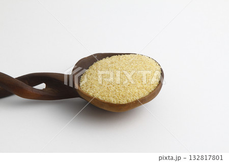 dry bulgur wheat in wooden spoon isolated on white background. top view dry bulgur wheat in wooden spoon isolated on white background. top view 132817801