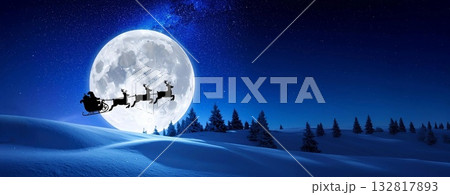 Santa claus and reindeer flying over snowy hills, delivering gifts under a full moon 132817893