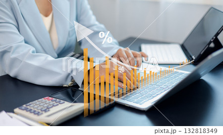Business growth and financial data analysis with increasing bar chart and person working on laptop 132818349