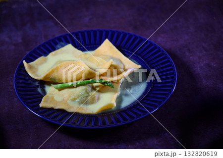 Large cornmeal dough ravioli with seafood on plate. Handmade work. Large cornmeal dough ravioli with seafood on plate. Handmade work. 132820619