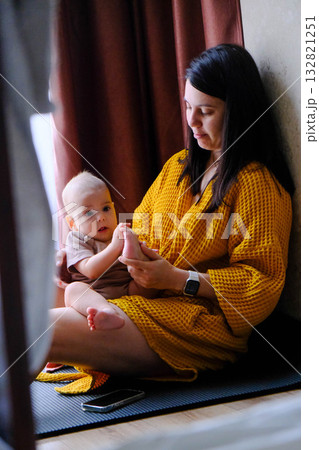 Mother and baby enjoying a cozy moment indoors Mother and baby enjoying a cozy moment indoors 132821251