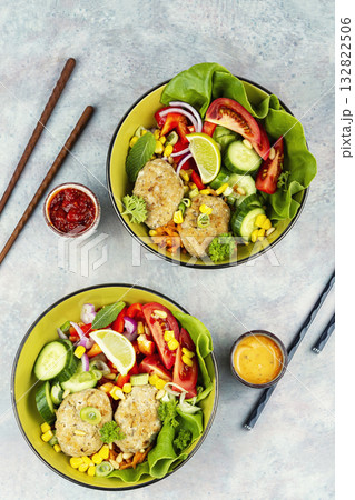 Fried cutlets in buddha bowl, fish patties. 132822506