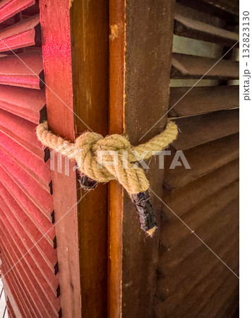 Strong Rope Knot on Wooden Shutters Rustic Detail and Texture 132823130