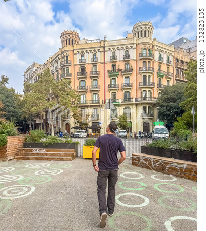 Man Walking Toward Historic Residential Building in City Square Man Walking Toward Historic Residential Building in City Square 132823135