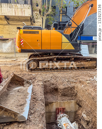 Excavator Working on Urban Construction Site with Deep Trench Excavator Working on Urban Construction Site with Deep Trench 132823136