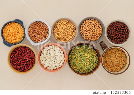 Top view. Protein products for vegetarians. Soy, lentils, peas, chickpeas and various types of beans in bowls. Variety of nutrients. Top view. Protein products for vegetarians. Soy, lentils, peas, chickpeas and various types of beans in bowls. Variety of nutrients. 132823360