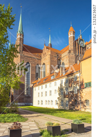 St. Mary's Church in Gdansk, a city on the Baltic coast of northern Poland, Europe. Historic cathedral with soaring spires, set against a clear blue sky, showcasing architectural grandeur. St. Mary's Church in Gdansk, a city on the Baltic coast of northern Poland, Europe. Historic cathedral with soaring spires, set against a clear blue sky, showcasing architectural grandeur. 132823607