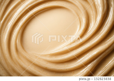 Creamy texture of smooth peanut butter swirled in a bowl ready for spreading or cooking Creamy texture of smooth peanut butter swirled in a bowl ready for spreading or cooking 132823838