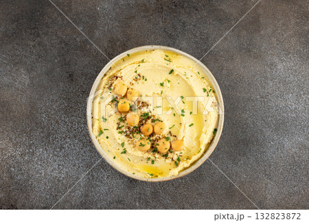 Lupini bean hummus with olive oil and herbs on gray background. Vegetarian food. Top view. Lupini bean hummus with olive oil and herbs on gray background. Vegetarian food. Top view. 132823872