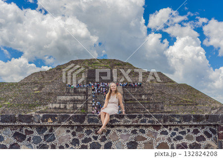 Female tourist standing in front of Teotihuacan pyramids in Mexico, enjoying sightseeing, adventure, and cultural heritage. Travel, tourism, and exploration concept Female tourist standing in front of Teotihuacan pyramids in Mexico, enjoying sightseeing, adventure, and cultural heritage. Travel, tourism, and exploration concept 132824208