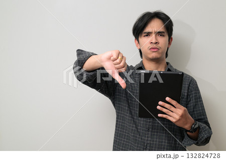 Portrait of handsome Young Asian Thai man using digital tablet computer against white background Portrait of handsome Young Asian Thai man using digital tablet computer against white background 132824728