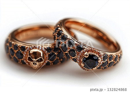 Pair of gold wedding rings with a skull pattern on a white background. Original style. Pair of gold wedding rings with a skull pattern on a white background. Original style. 132824868