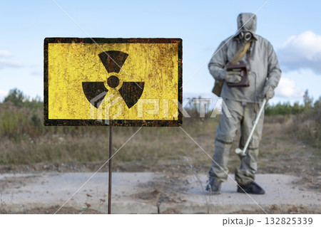 Old textural sign of radiation hazard, military chemical reconnaissance measures the level of radiation against the background of contaminated nature. Old textural sign of radiation hazard, military chemical reconnaissance measures the level of radiation against the background of contaminated nature. 132825339