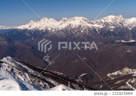Mountains Caucasus Russia Winter: Panoramic view snowy peaks, valleys, resorts, showcasing breathtaking scenery. 132825669
