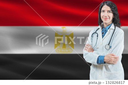 Egyptian medicine and healthcare concept. Close up of doctor against Egypt flag background Egyptian medicine and healthcare concept. Close up of doctor against Egypt flag background 132826817