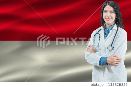 Indonesian medicine and healthcare concept. Doctor close up against Indonesia flag background 132826825