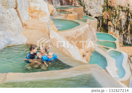 Mother with her toddler and teenage son bathing in the hot springs of Grutas Tolantongo, Mexico, enjoying family bonding, wellness, and outdoor adventure concept. Mother with her toddler and teenage son bathing in the hot springs of Grutas Tolantongo, Mexico, enjoying family bonding, wellness, and outdoor adventure concept. 132827214